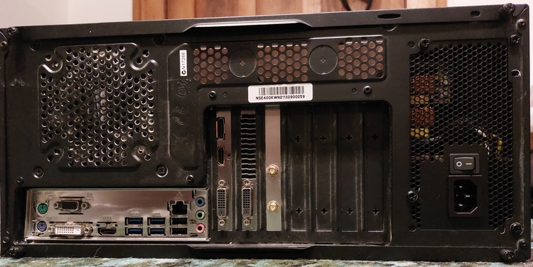 Back of my PC on its side, with graphics card and wifi card (currently redundant) in the expansion slots